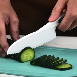 Safe children plastic knife for cutting fruits, vegetables, and cakes with serrated blade.