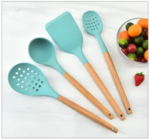 Silicone kitchen utensil detail view featuring heat-resistant teal head and natural wood handle.
