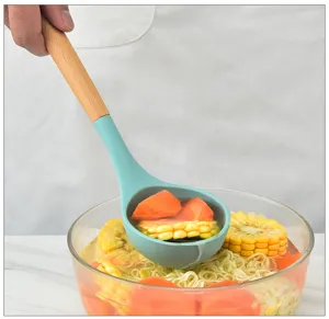 Detail shot of a turquoise silicone soup ladle with wooden handle in kitchen scene usage.