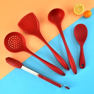 Complete red silicone kitchen utensil set featuring spatula, ladle, and tongs for cooking.