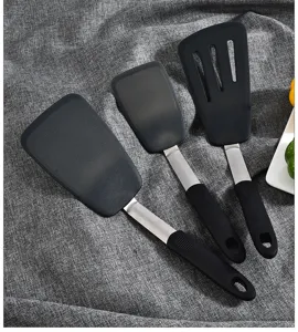 Detailed view of black silicone cooking spatula set with durable stainless steel handle.