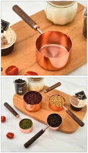 Stainless steel measuring cups and spoons set with walnut wooden handle for home baking use.