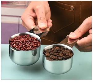 Stainless steel measuring cups set with clear scale markings for baking and cooking use easily.