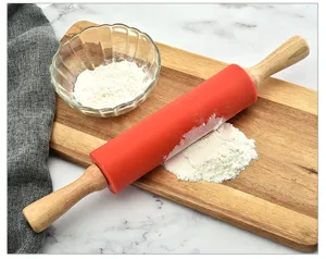 Silicone rolling pin with wooden handle for baking, non-stick kitchen tool detail view.