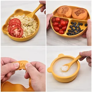 Baby silicone feeding set with bear bowl, divided plate, spoon, and bib for toddlers.