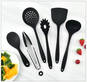 Black silicone kitchen utensil set, heat-resistant spatula, soup ladle and tongs for cooking.