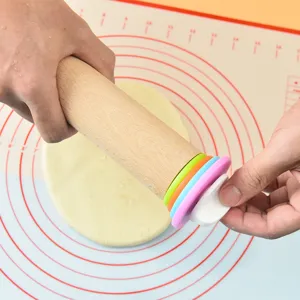 Adjustable wooden rolling pin and silicone baking mat set with precise measurement scales.
