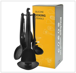 Close-up detail of black silicone kitchen utensil set on stand with packaging box.
