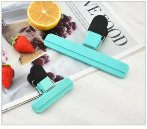 Cyan and black plastic food sealing bag clips detail view, ideal for kitchen snack storage.