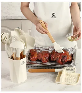 Silicone kitchen utensil set detail showing wooden handle and brush tool in home kitchen.