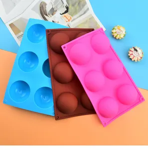 Detail view of 6-hole silicone hemisphere molds in blue brown and pink for DIY baking ice balls.