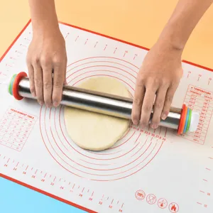 Stainless steel rolling pin and silicone baking mat set with measurements for kitchen use.