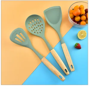 Wooden handle silicone kitchen utensils detail view showing slotted turner and cooking tools.