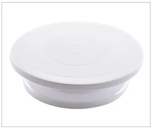 White plastic cake turntable detail shot, smooth rotating pastry stand for baking and decorating.