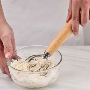 Stainless steel dough whisk with wooden handle, perfect for baking bread, pastry, and mixing flour efficiently.