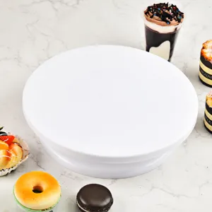 White plastic cake turntable for baking, smooth rotating stand for decorating cakes and desserts.