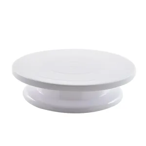 White 10-inch plastic cake turntable for baking and decorating, smooth rotating stand.