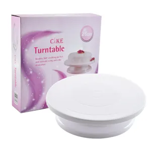 White plastic cake turntable with pink packaging box for baking and cake decorating decoration.
