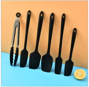Black silicone kitchen utensil set with spatulas and tongs for cooking, kitchen tools.