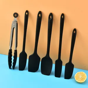 Black silicone kitchen utensil set, heat-resistant spatulas and food tongs for cooking.