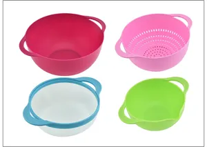 Plastic kitchen colander and strainer detail, colorful bowls with handles for washing food.
