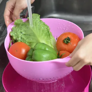 Pink plastic kitchen colander double layer drain basket for washing vegetables fruit.
