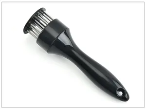 Stainless steel meat tenderizer tool with needles for beef and pork cooking prep detail shot.