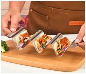Stainless steel taco holder detail view, wave shaped rack perfectly showcasing Mexican food.