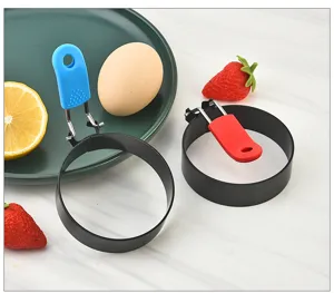 Stainless steel fried egg ring detail view, round breakfast mold with heat resistant handle.