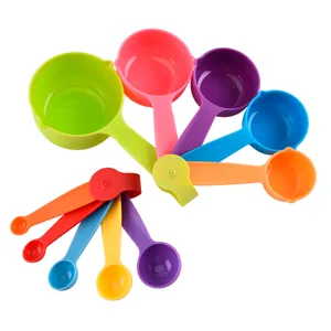 Colorful plastic measuring cups and spoons set for kitchen baking and cooking measurements.