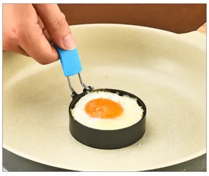 Stainless steel round fried egg mold close-up, convenient kitchen tool for making breakfast.