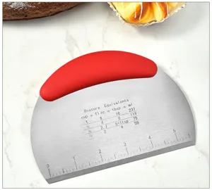 Stainless steel dough scraper detail, baking cutter tool with red handle and measurement scale.