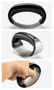 Stainless steel garlic press with ergonomic black handle, curved kitchen mincer tool detail.