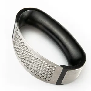 Stainless steel curved garlic press with ergonomic black plastic handle for kitchen use.