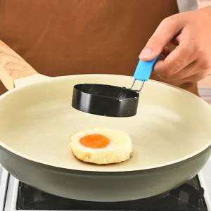 Stainless steel round fried egg mold for kitchen breakfast cooking, useful for poached eggs.