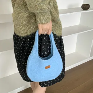 Detailed view of the cute light blue knitted fuzzy handbag showcasing daily autumn style.