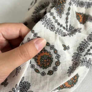 Fabric detail close-up of the vintage floral print silk scarf, lightweight and breathable material.