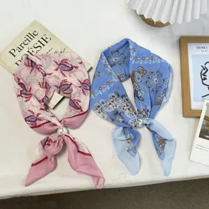 Detailed shot of Japanese literary retro paisley printed small silk scarf with pearl accessory.