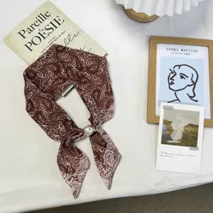Vintage brown paisley print silk scarf with elegant pearl buckle, chic neckerchief accessory.