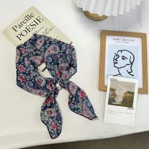 Detailed view of vintage navy blue paisley floral printed silk scarf with elegant pearl ring buckle.