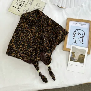 Detailed view of a retro leopard print pleated triangle headscarf with chic beaded tassel accents.