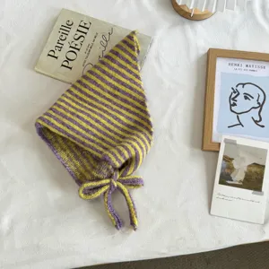 Close-up detail of Korean style striped knitted triangular headscarf in yellow and purple.