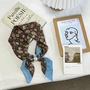 Chic brown paisley printed silk square scarf with elegant pearl buckle for women commuting.
