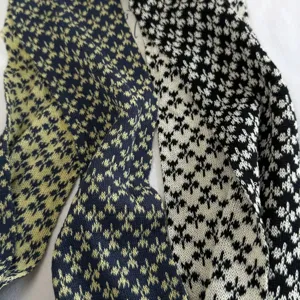 Detailed view of the autumn snowflake knit long scarf, featuring soft textured patterns.