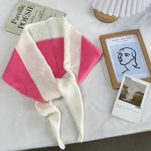 Detailed view of the pink and white color block knitted triangle scarf, warm and cozy neck warmer.