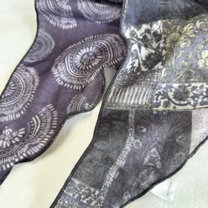Vintage print triangle scarf detail showing retro paisley pattern and fabric texture.