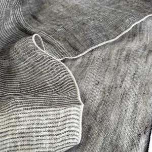Close-up detail of vintage linen square scarf showing soft texture and fine stitched hem.
