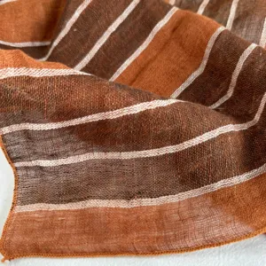 Close-up detail shot of retro striped linen square scarf showing fine texture and stitching.