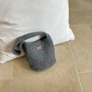 Gray felt bucket handbag detail view, minimalist style wool tote bag showcasing texture.
