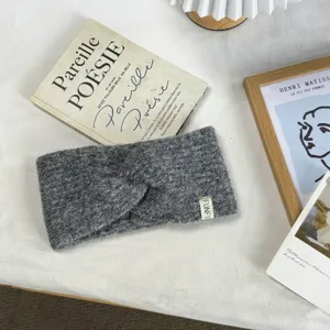 Dark grey knitted twist headband for women, cozy winter warm hair accessory style.